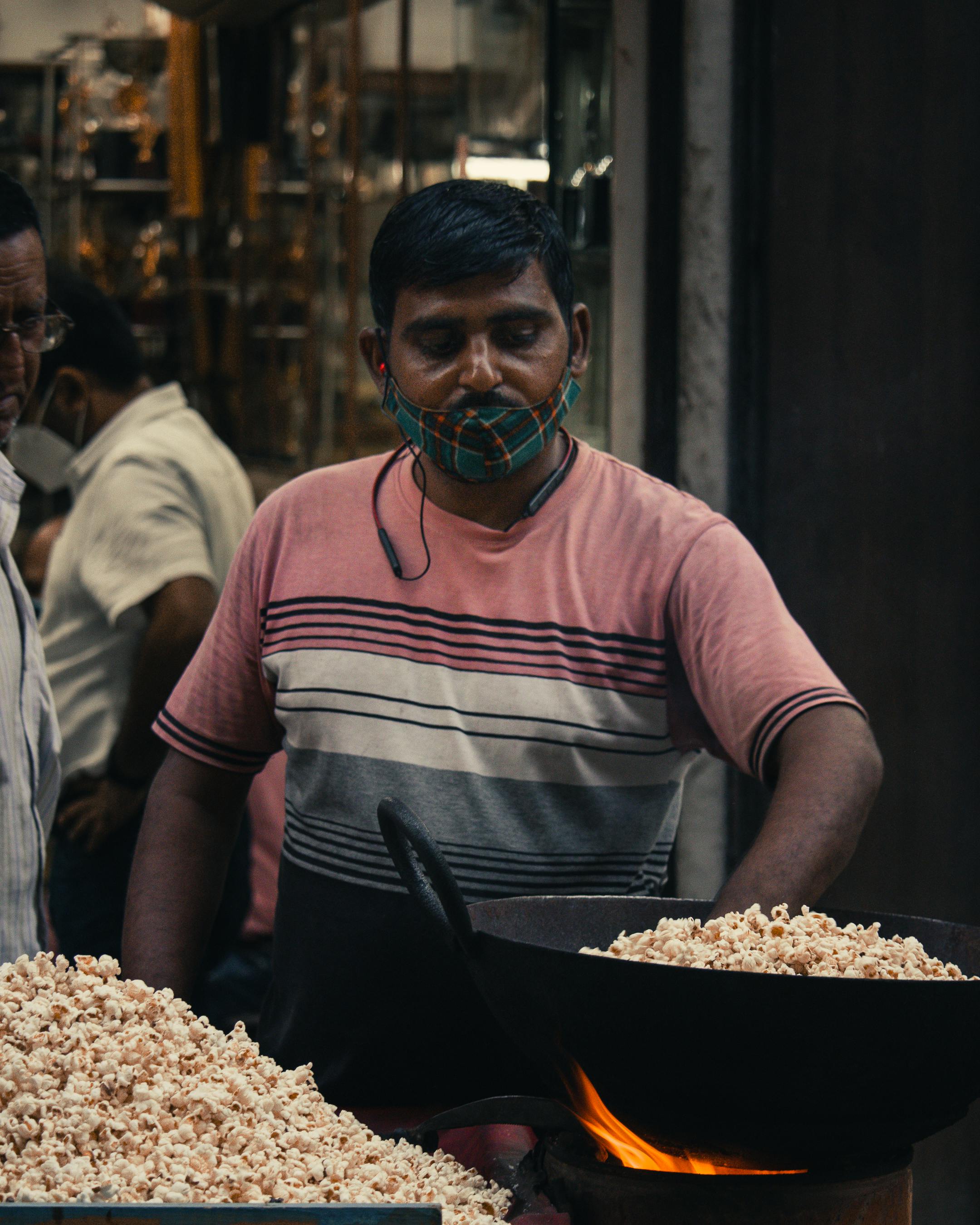 Photo of a Man Cooking Popcorn · Free Stock Photo