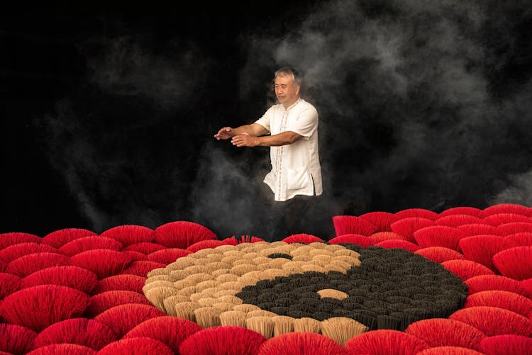 Man In Smoke Among Flowers