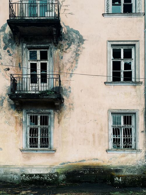 Free A weathered facade of an abandoned building in Tkvarcheli, showcasing decayed architecture. Stock Photo