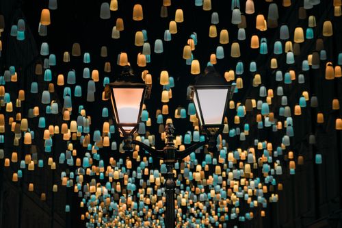 Free Street lamps surrounded by colorful illuminated shades in Moscow's nighttime cityscape. Stock Photo