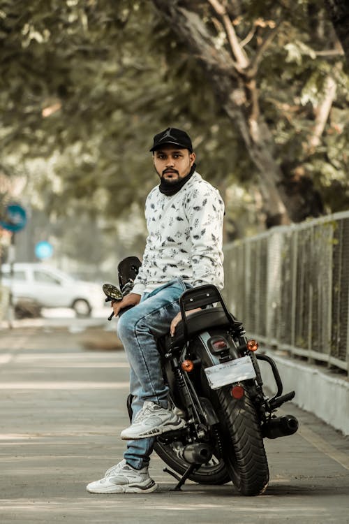 A Bearded Man Sitting on His Motorcycle 