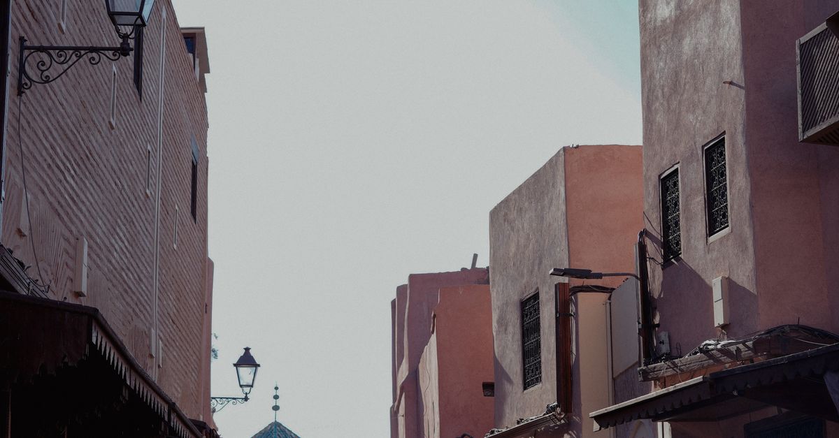 Capture of an old street in Marrakesh's Medina, showcasing Moroccan architecture and vibrant atmosphere.