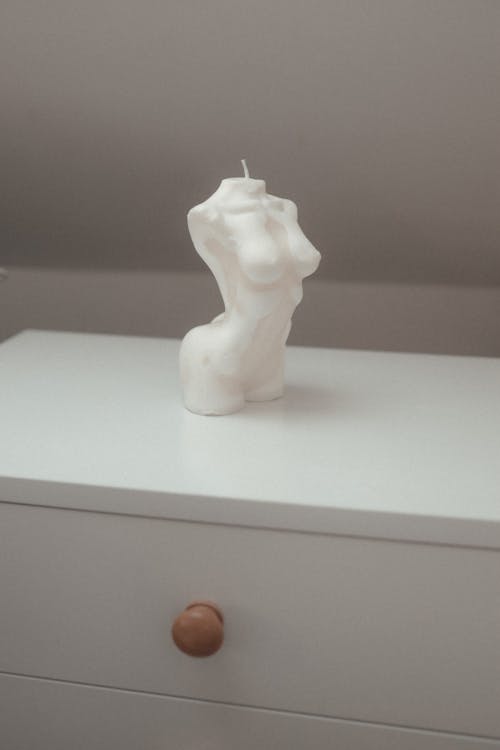Human Body Candle on White Cabinet 