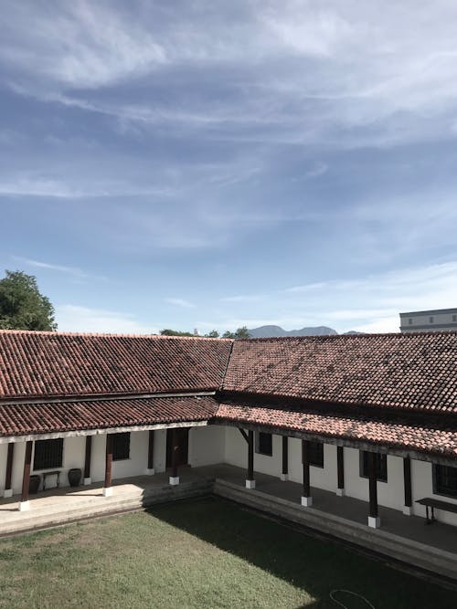  White Concrete House with Brown Roof Tiles 