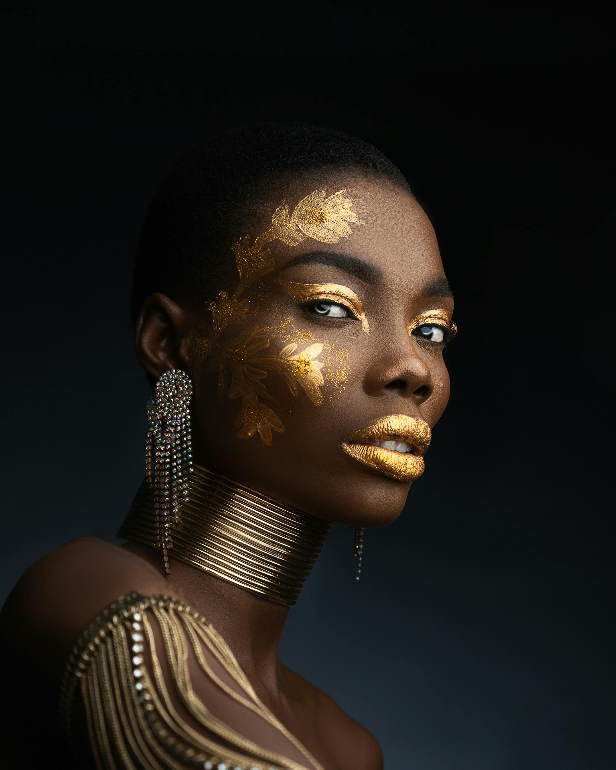 woman with gold eyeshadow and gold lisptick