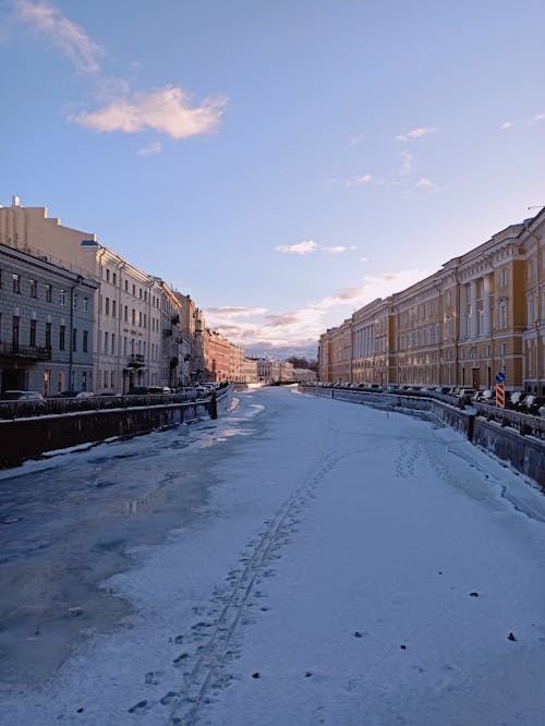 Snow Covered Road Between Buildings