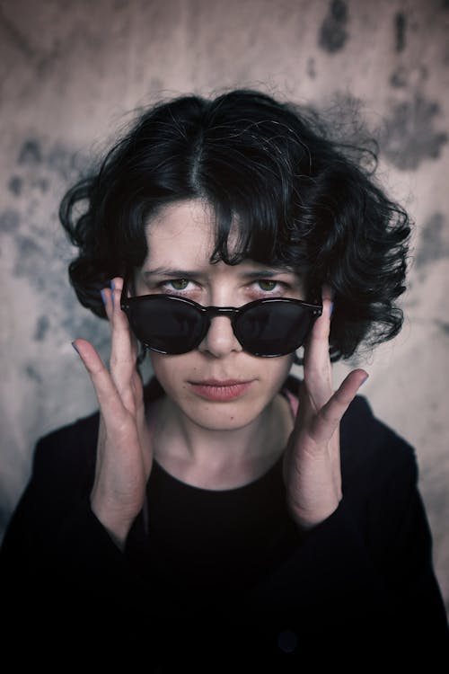 Woman Looking Over Her Sunglasses