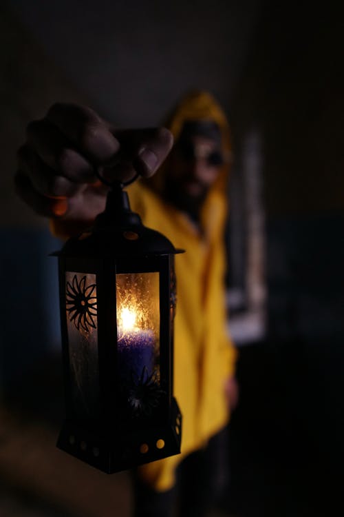 Selective Focus of a Person Holding a Candle Lamp