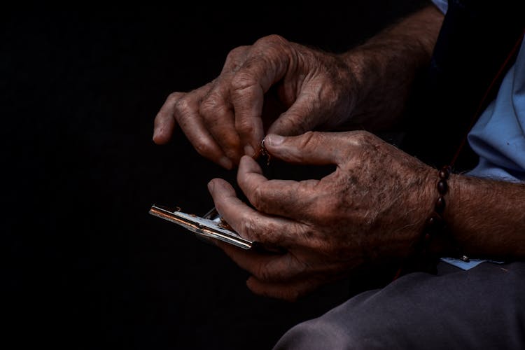 A Man Rolling A Cigarette