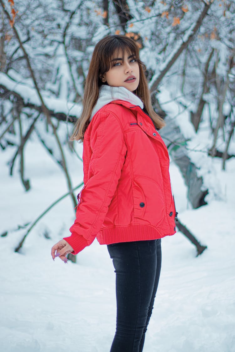 Woman In Red Jacket Standing On Snow