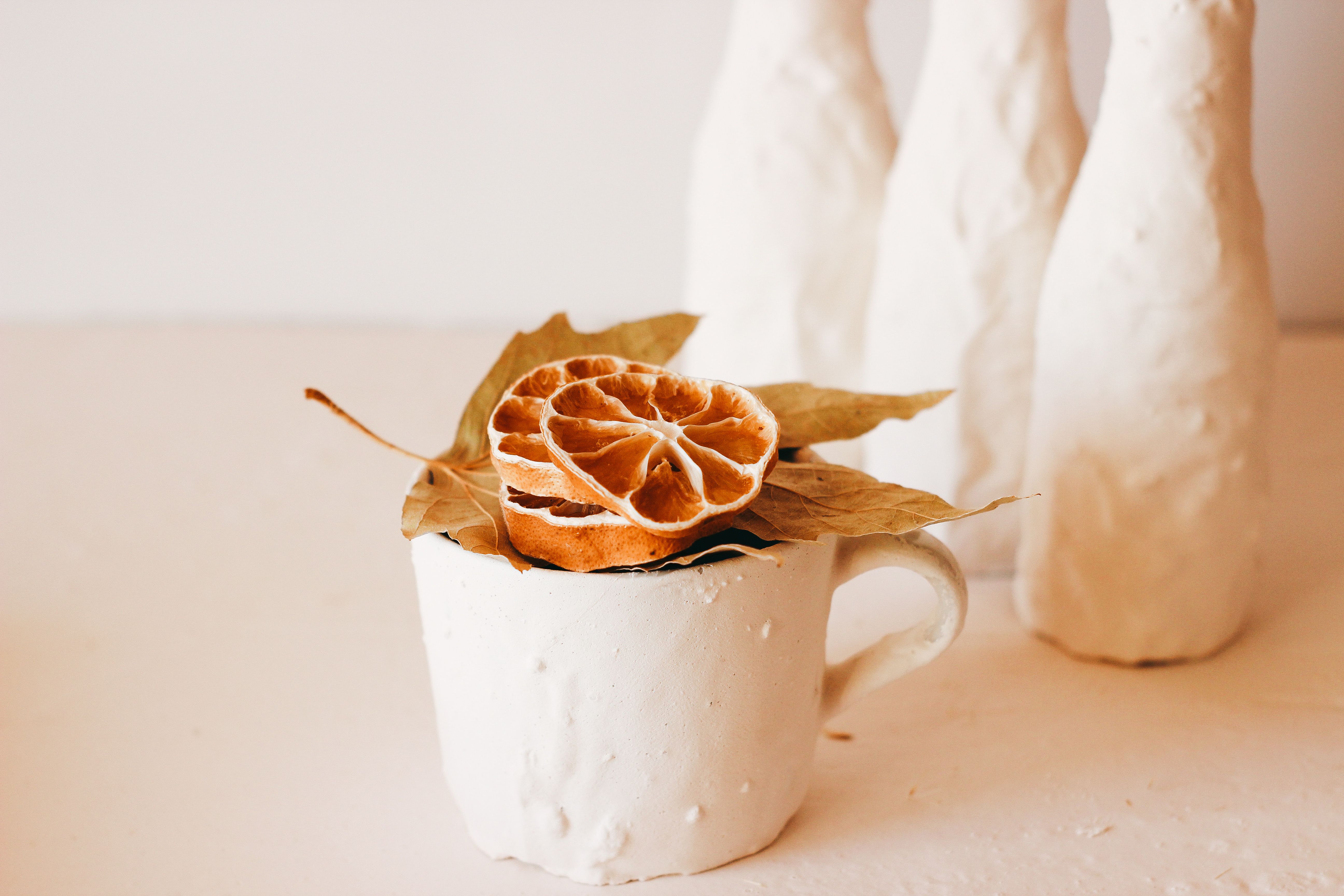 White Ceramic Mug with Dried Leaf and Orange Slices