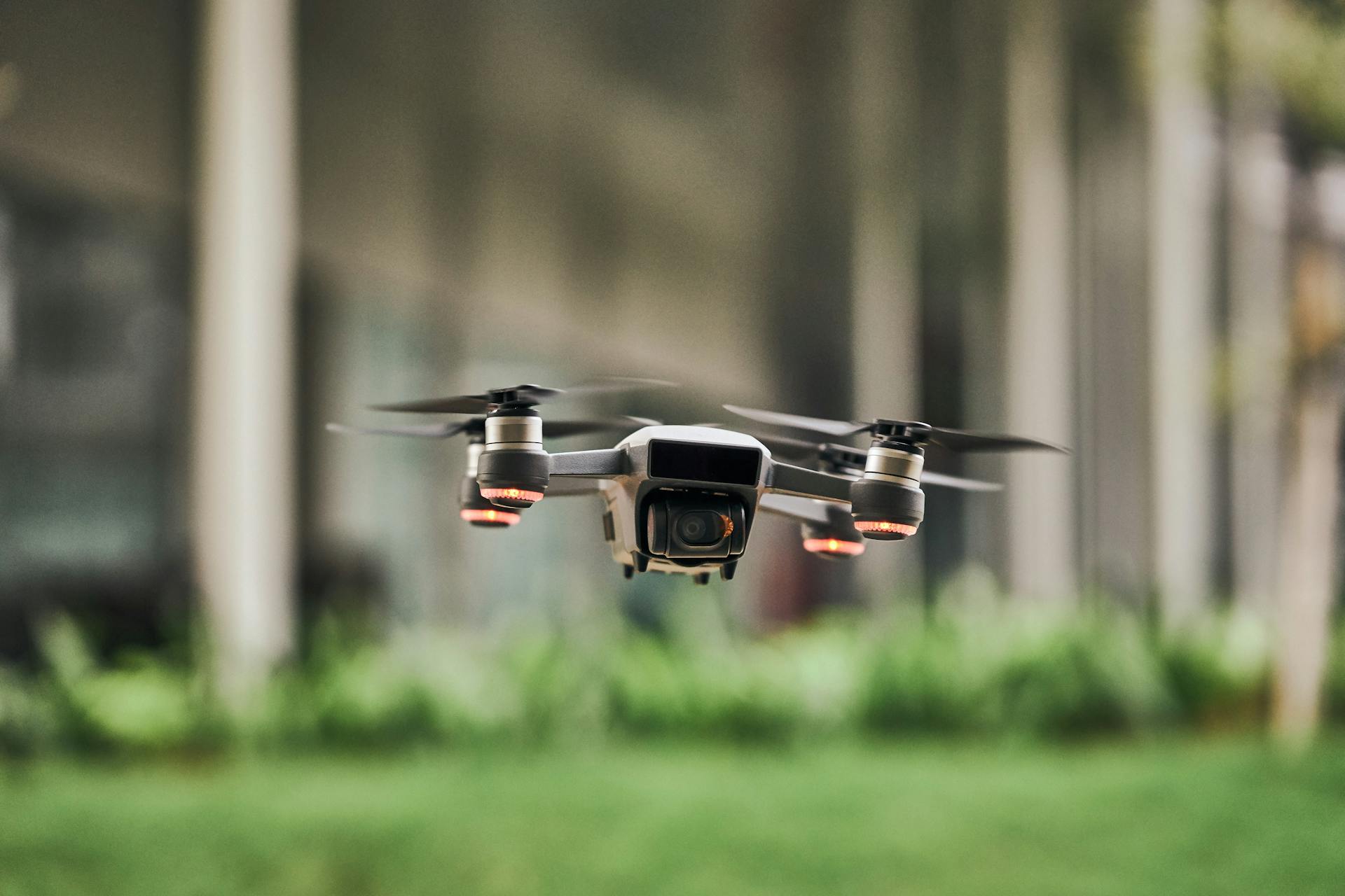 Close-up of a compact drone in flight outdoors, showcasing modern flying technology.