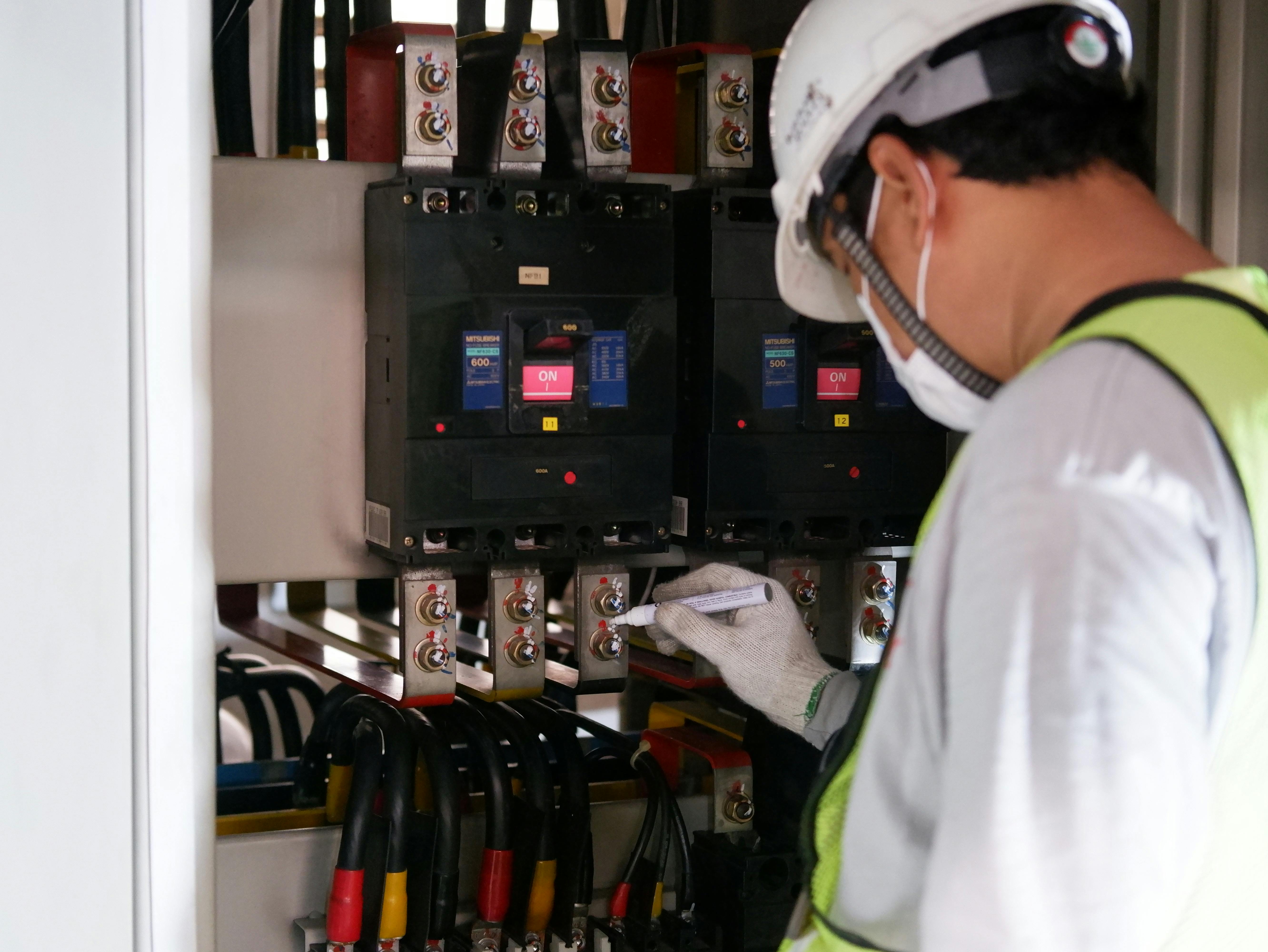 Image Name close-up of an electrician checking the power voltage of a house