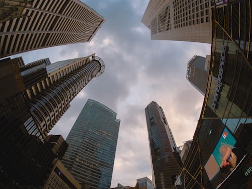 Free Low Angle Shot of High-Rise Buildings Under the Cloudy Sky  Stock Photo