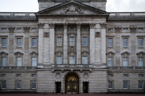Free The iconic front facade of Buckingham Palace in London on a cloudy day. Stock Photo