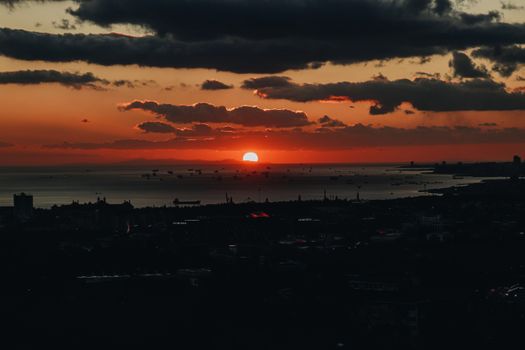 Capture the breathtaking view of the sunset casting vibrant hues over the ocean horizon.