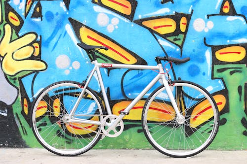 A Bicycle Leaning on Graffiti Wall