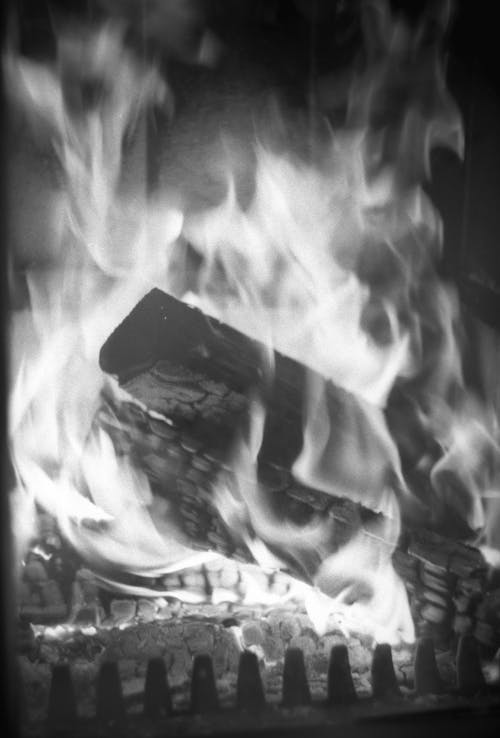 Grayscale Photo of Burning Wood
