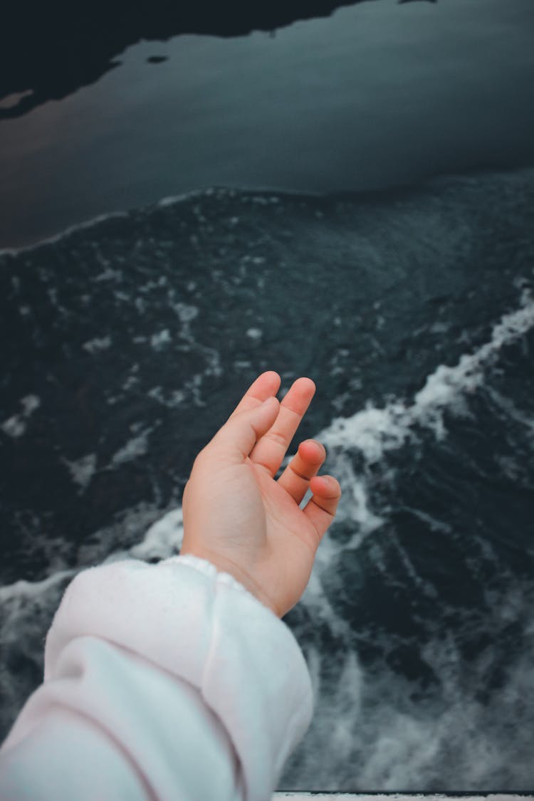 Hand Of A Person In White Long Sleeve