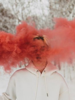 Man in White Zip Up Jacket With Red Powder on His Face