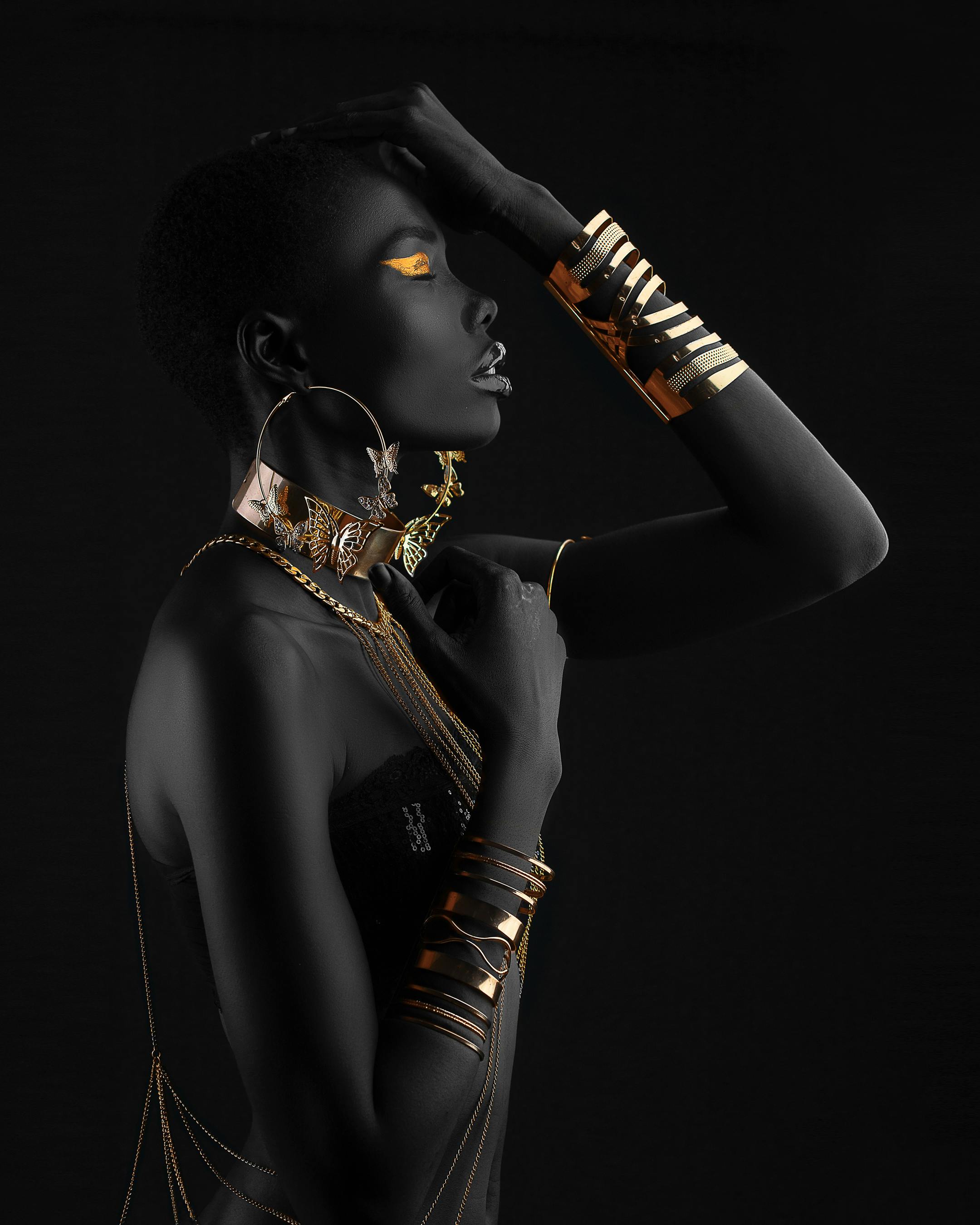 side view of a woman wearing gold accessories