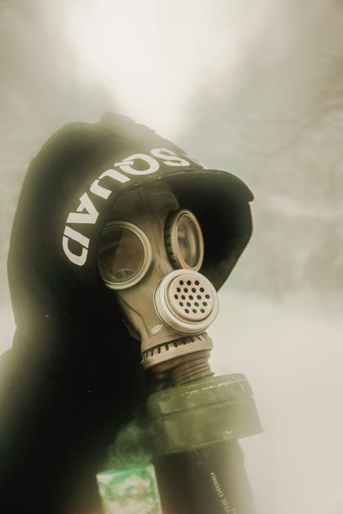 Person in Black Hoodie Wearing Gas Mask