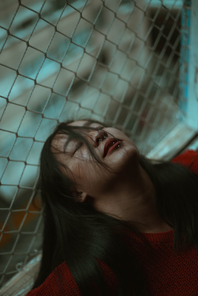 Woman With Long Hair, Piercings And Eyes Closed