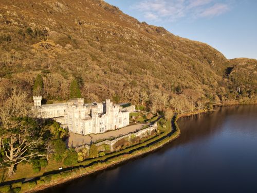 Free Aerial view of the historic Kylemore Abbey nestled in the Galway mountains by a tranquil lake. Stock Photo