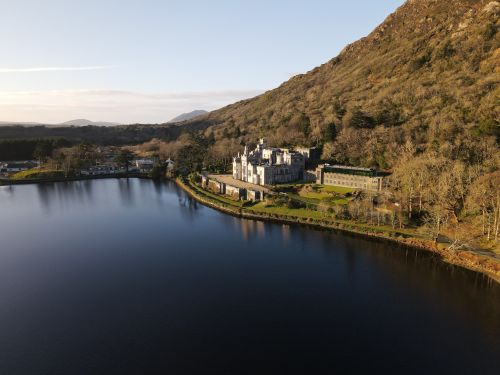Free Scenic aerial photograph of historic Kylemore Abbey beside a tranquil lake in Ireland. Stock Photo