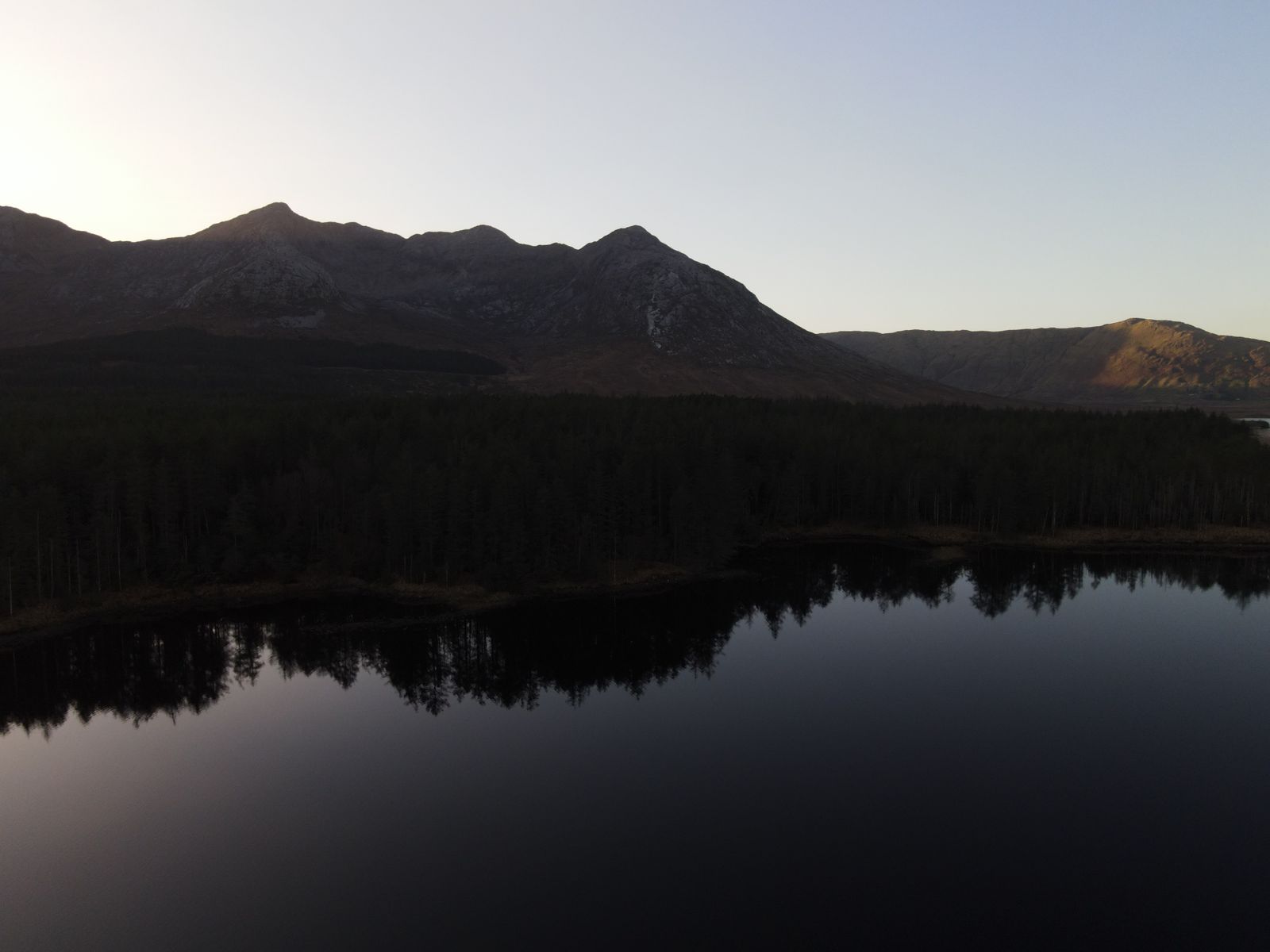 Drone view of landscape with mountain and lake reflections in Connemara, Ireland