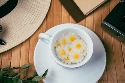 A warm cup of chamomile tea with chamomile flowers