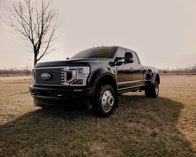 White Ford F 150 Crew Cab Pickup Truck On Grass Field