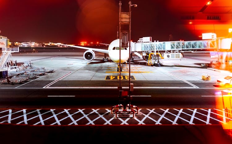 White Airplane On Airport During Night Time