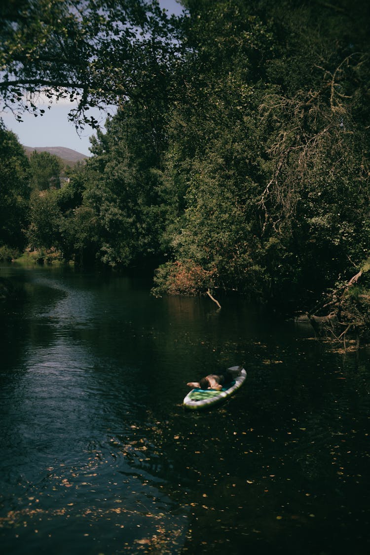 Man Relaxing On A Standup Paddleboard In A Lake 