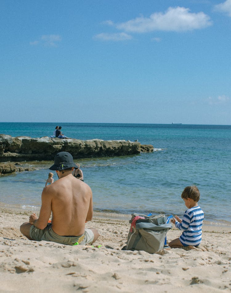 Father With Son On Sandy Beach