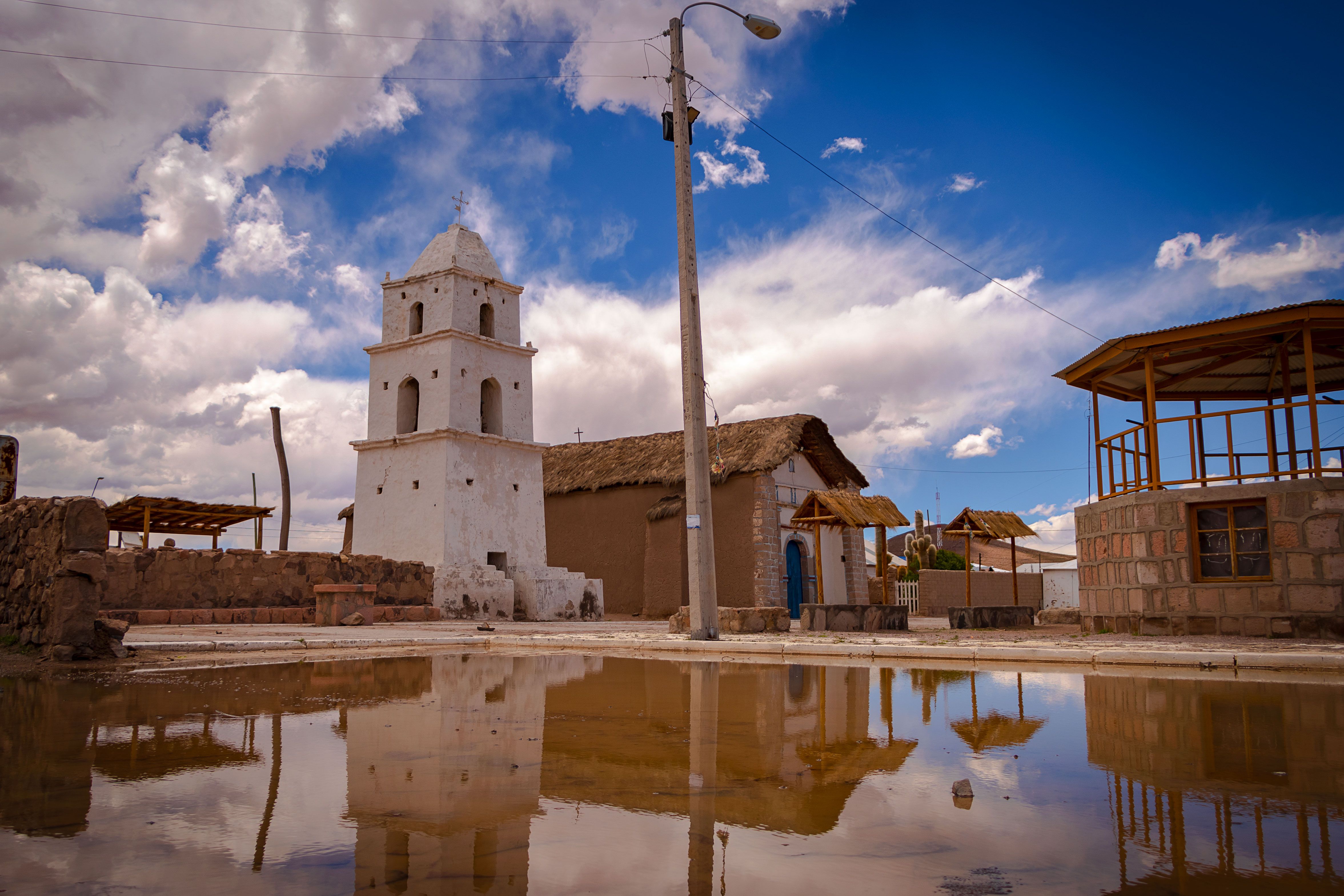 Coffee drying patios and a pale church tower in Santa María, La Paz