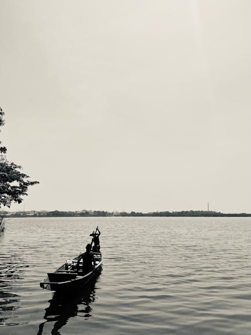 Black and White of Two Men Riding a Boat in the Sea