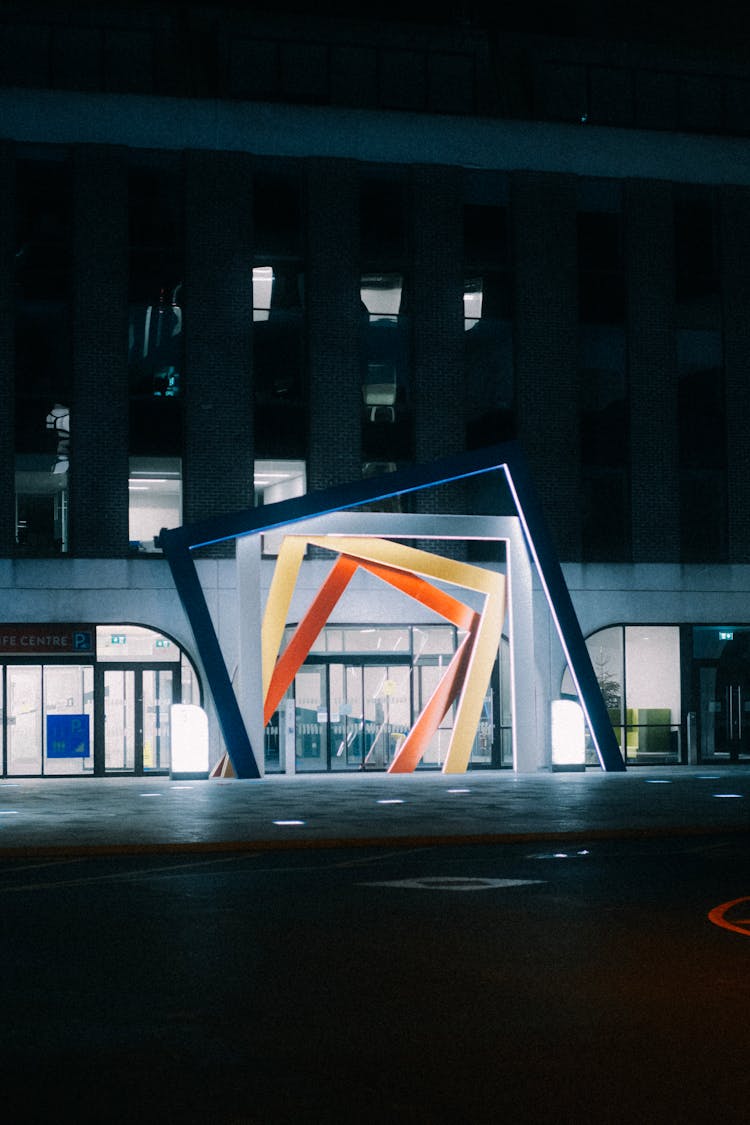 Futuristic Sculpture In Front Of A Modern Building 