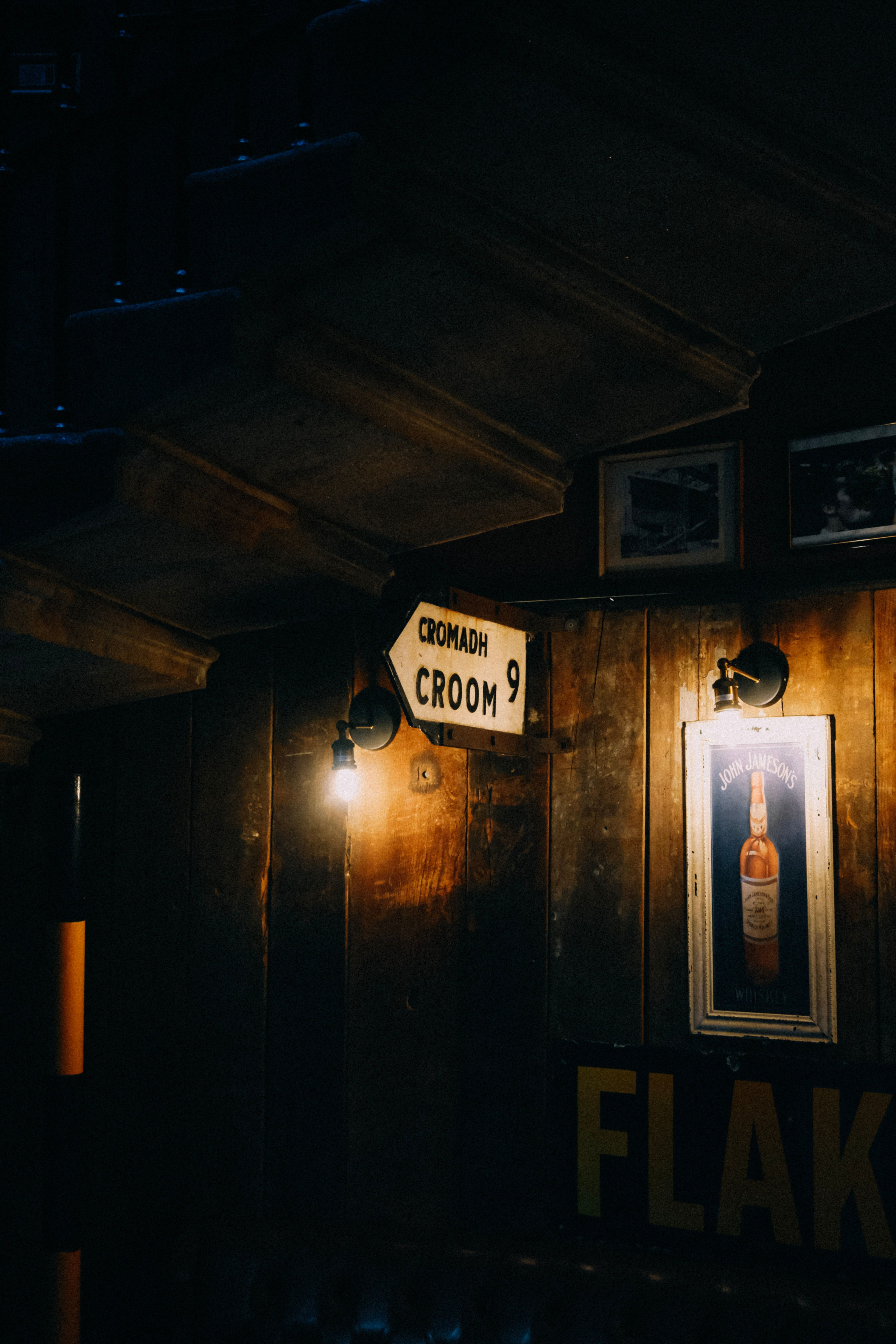 Cozy interior with rustic decor, vintage signage, and dim lighting for a warm ambiance.