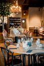 Empty Tables at Restaurant with Lemon Tree Growing Inside