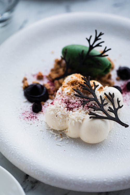 White Ice Cream Balls Decorated with Chocolate and Fruit Sauce