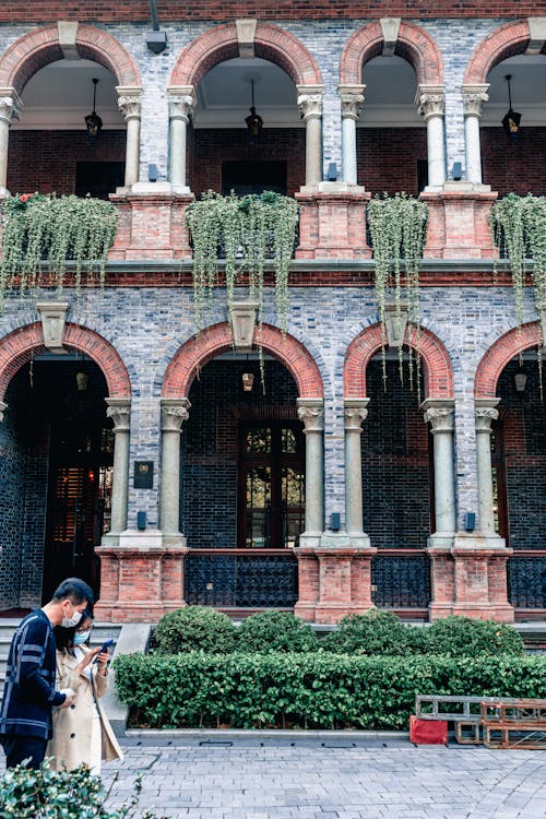 A Couple in Front of a Building