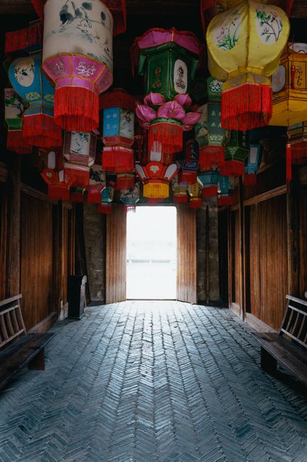 Colorful lanterns adorn a traditional Chinese corridor, highlighting cultural heritage and festive decoration.