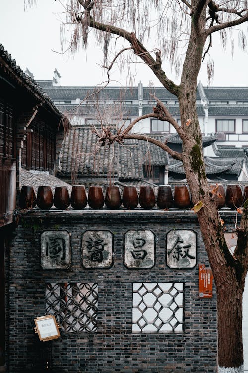 Ceramic Containers on a Wall at a Buddhist Temple 