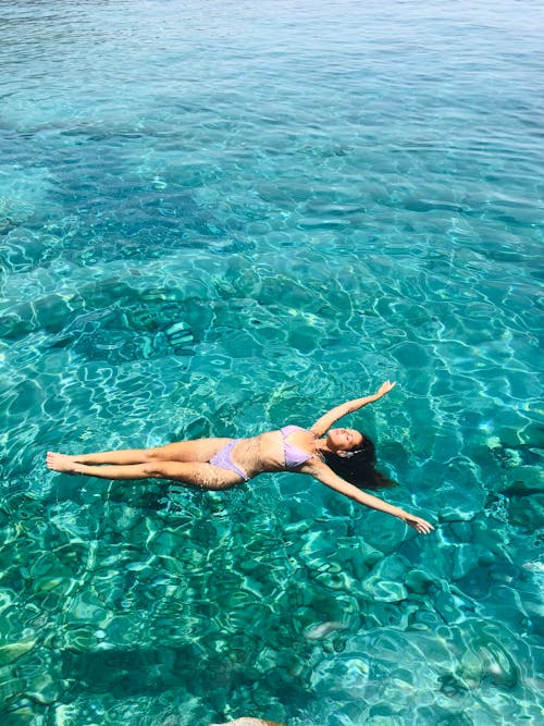Woman in a Bikini Floating on the Water