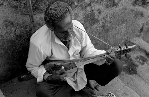 Black and White of a Man Playing a Musical Instrument