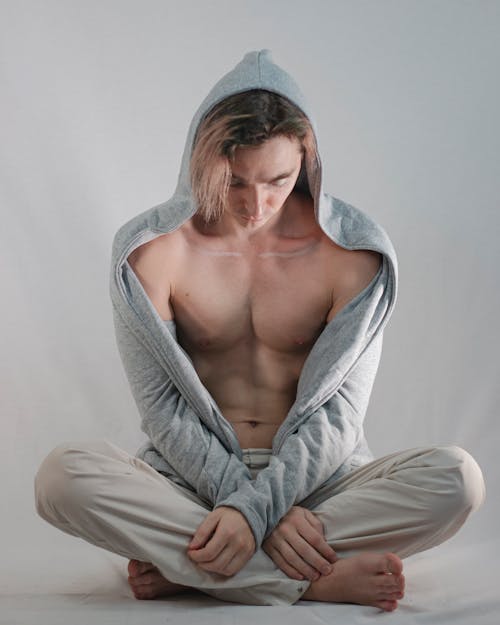 Man Wearing Gray Hoodie in Indian Sit Position