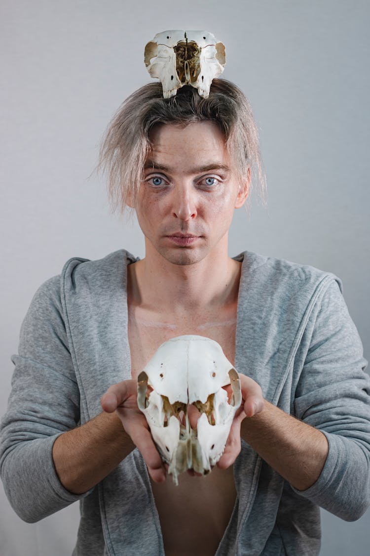 Man With Animal Skull On His Head And Hand