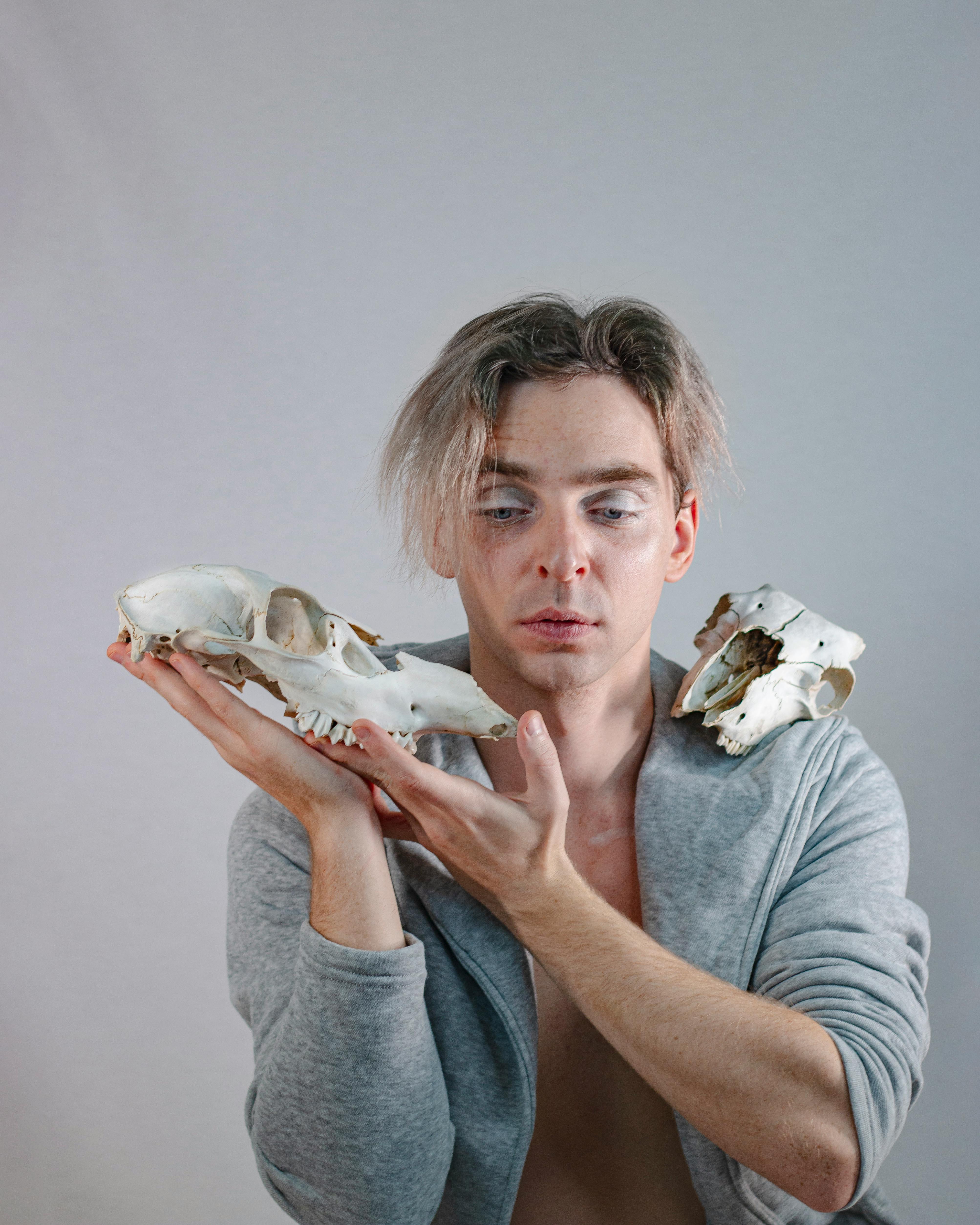 A Man Posing with Animal Skulls · Free Stock Photo