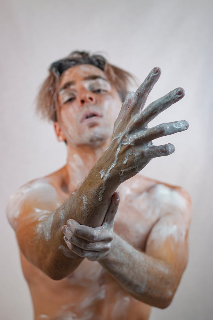 Man In White Paint Reaching Out